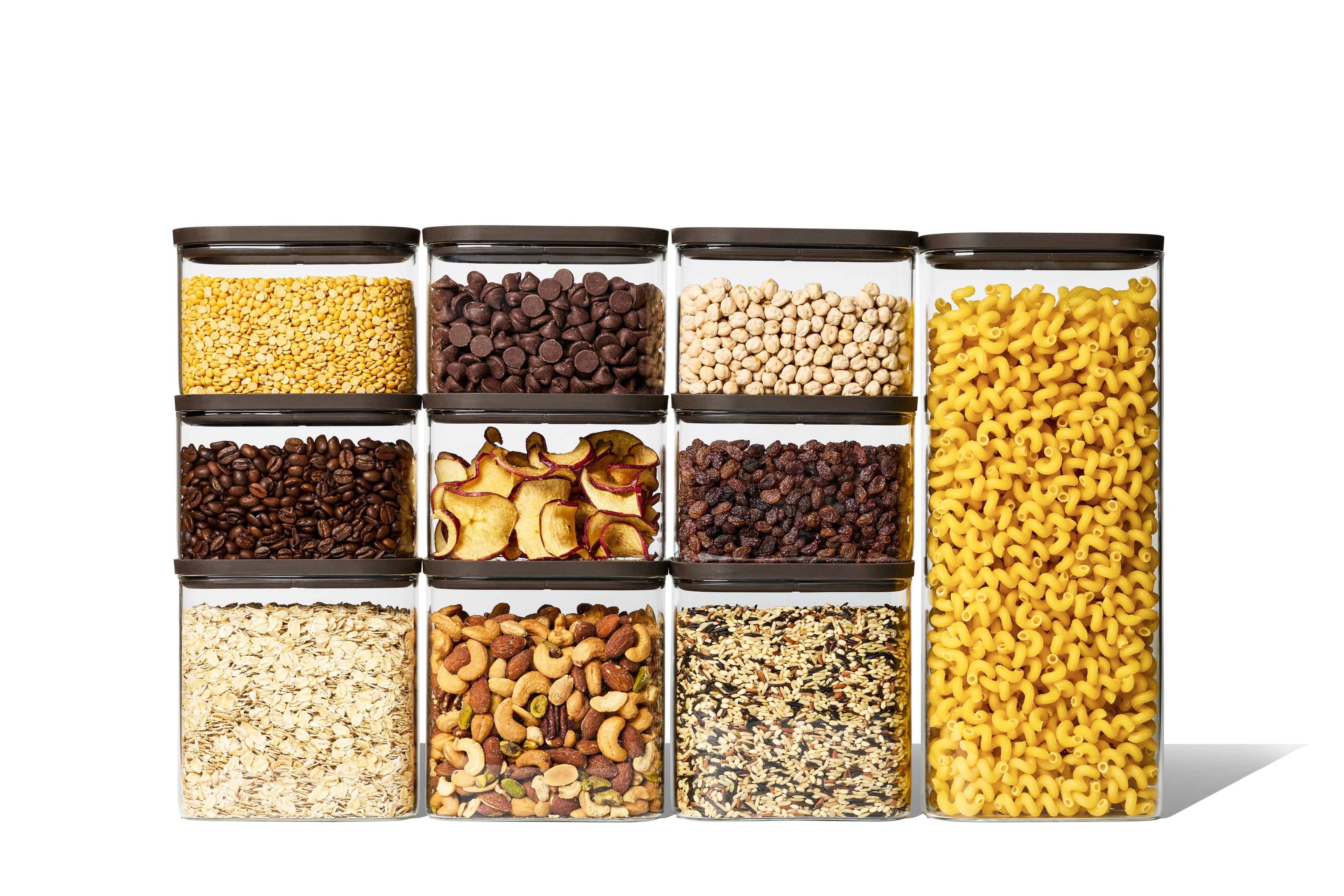 Full Naked Kitchen 20-piece glass countertop set with black lids holding pantry staples including pasta, grains, nuts and coffee