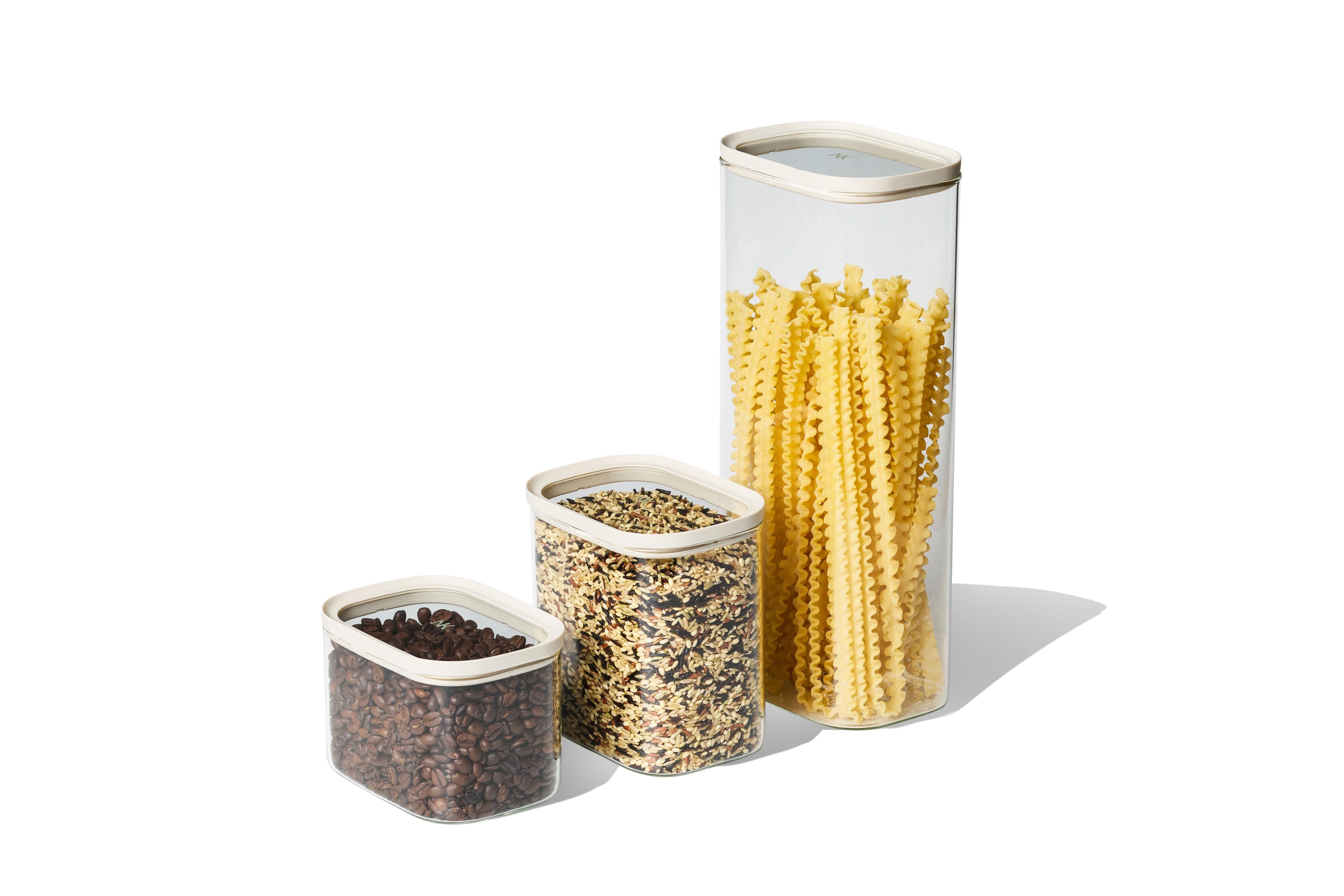Naked Kitchen glass countertop canisters in three sizes storing coffee beans, grains and long pasta