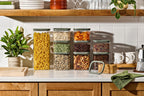 Naked Kitchen glass canisters with green lids organizing pasta, grains and nuts on a styled kitchen counter